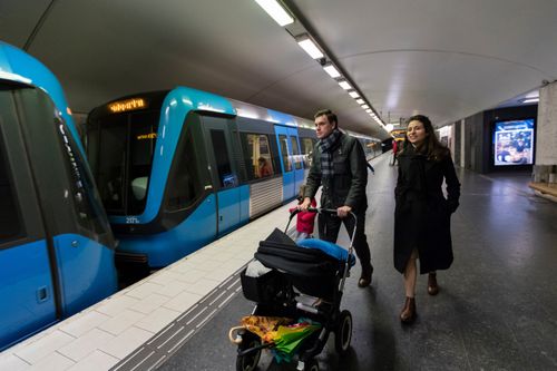 family next to a subway train