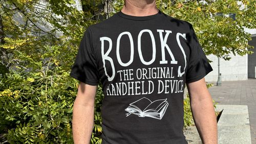 T-shirt proclaiming, “Books: The Original Handheld Device.”