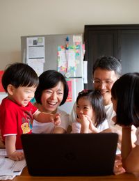 Family members in Taiwan use their computers to do family history.