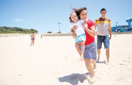 Darren and Stacey with daughter at the beach