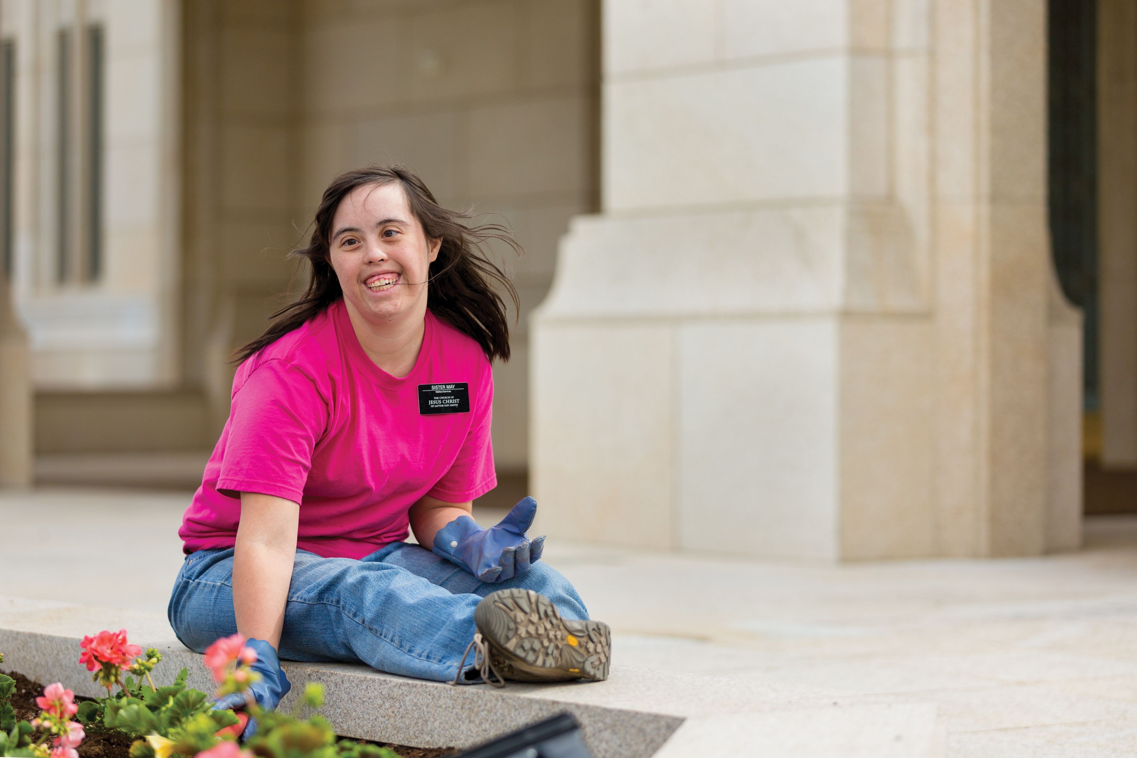 A Church-service missionary works in a flower bed at the Ogden Utah Temple.