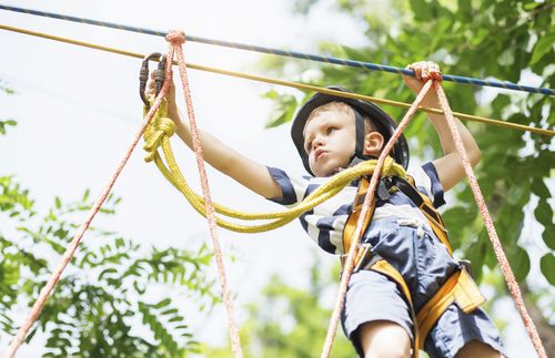 little boy on a zipline