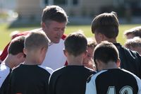 youth sports team gathered near coach