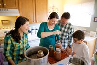 family working together on food preservation