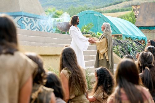 The resurrected Savior, Jesus Christ, appears to the ancient inhabitants of the Americas. Jesus holds out his hands and allows Nephi to touch them.