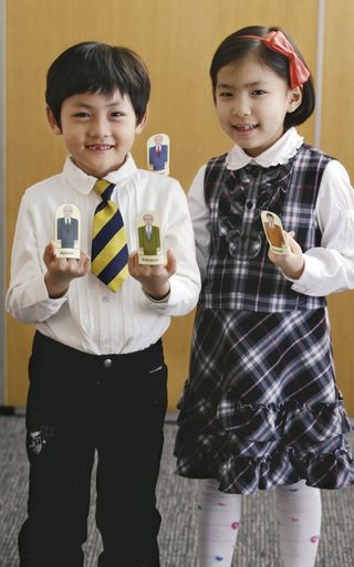 A girl and boy holding up images representing the offices in the priesthood.