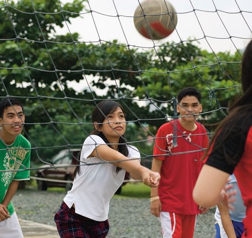 youth playing volleyball