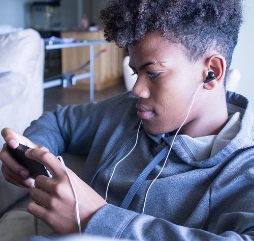 man listening to device with headphones