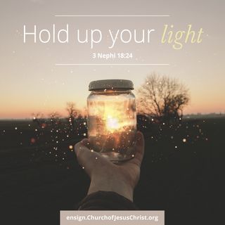 hand holding up a glass jar with light shining through it