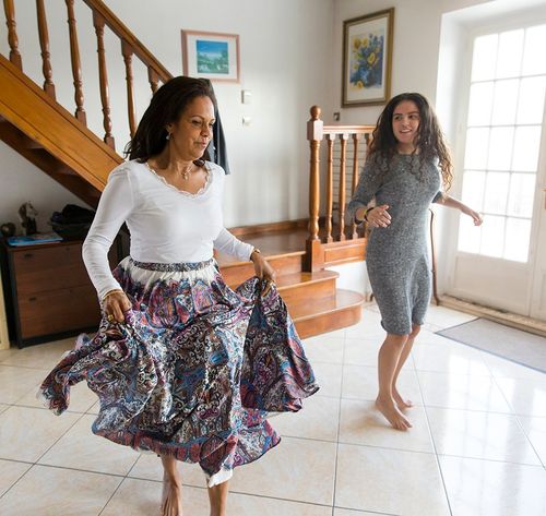 two women dancing in a home