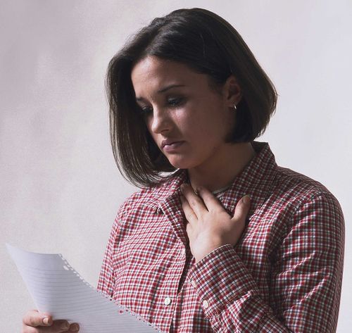 sad woman reading note