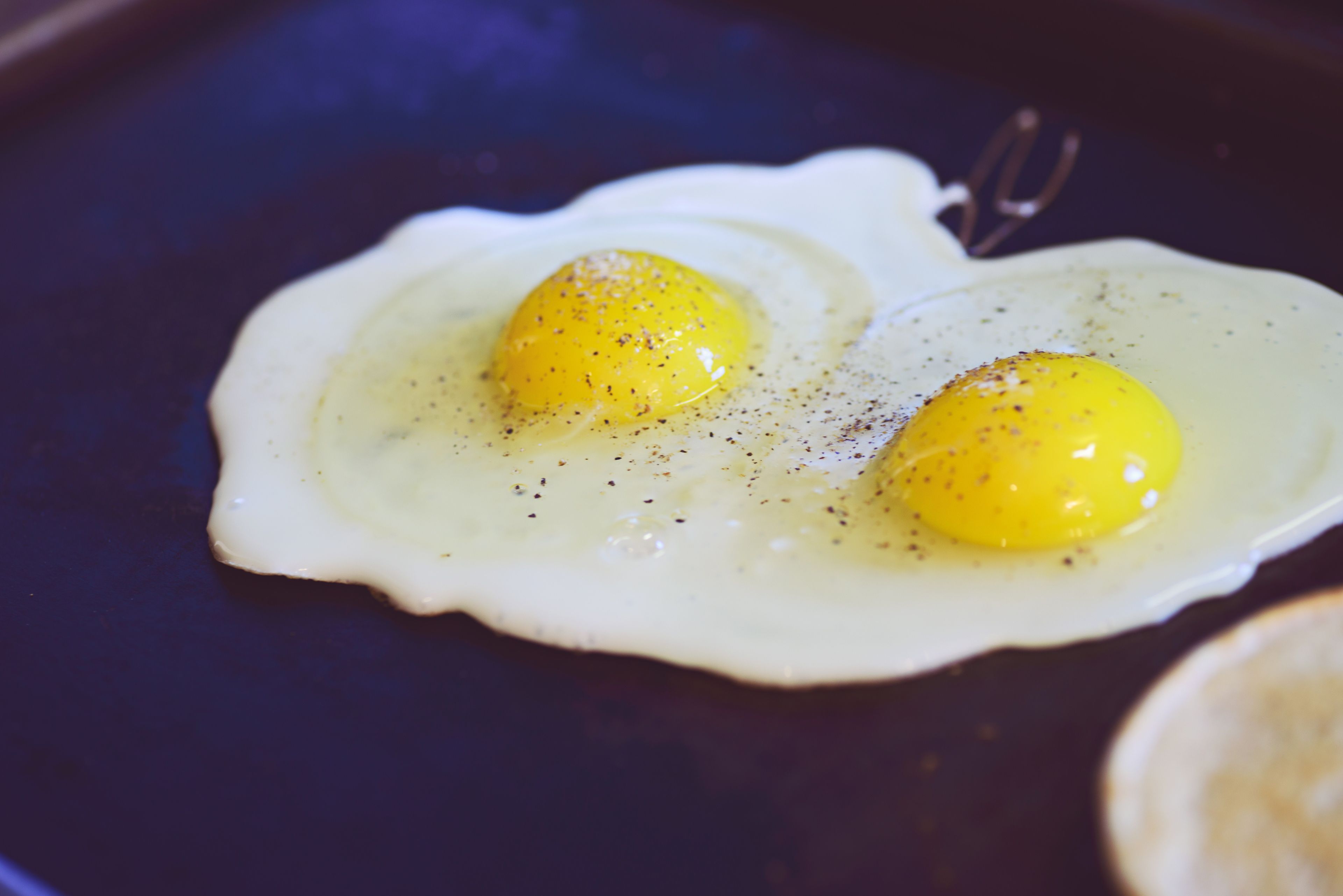 Fried eggs on a skillet.