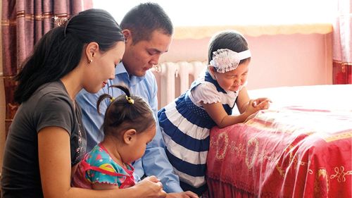 family praying together