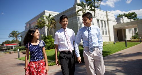 Paraguay. A young woman and two young men on the grounds of the Asuncion Paraguay Temple.