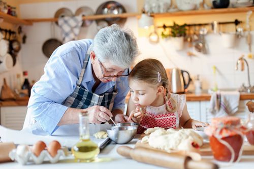 a grandmother and a child making a meal together