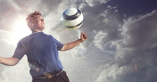 Soccer player with ball ricocheting off his chest.