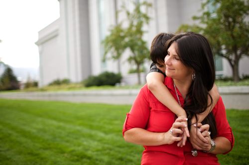 woman holding small boy on her back