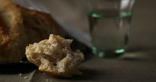 Clump of bread and glass of water for sacrament.