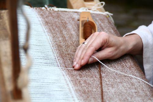 fabric being woven on a loom