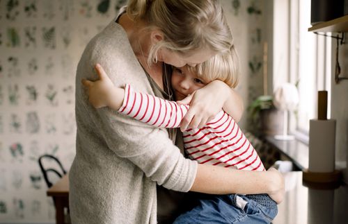 woman hugging child