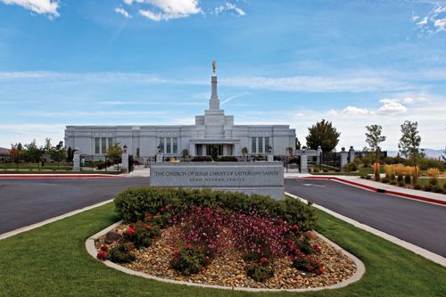 The entire Reno Nevada Temple, including the temple name sign out front and a road leading up to the entrance of the temple.