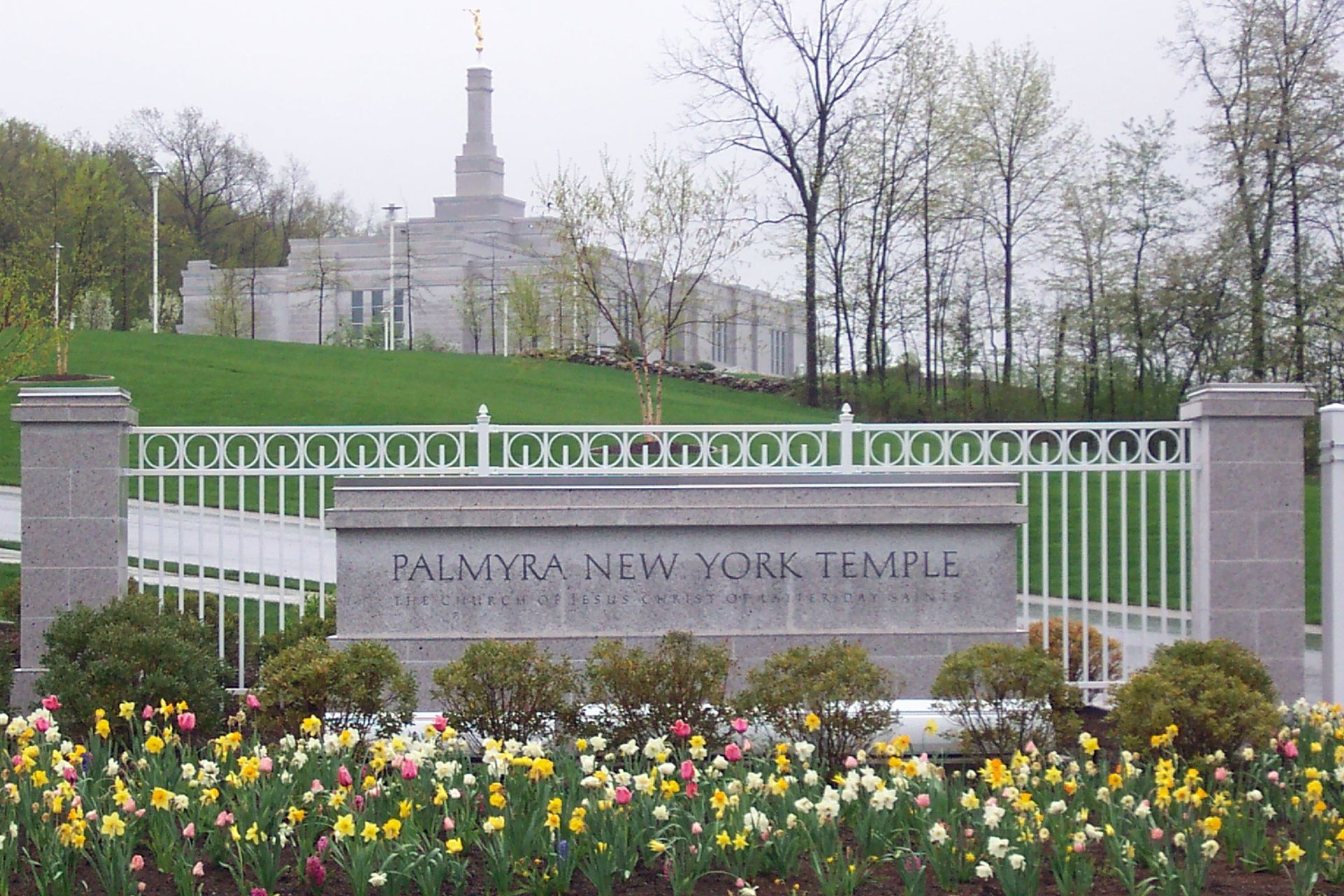 The Palmyra New York Temple name sign, including scenery and the temple exterior.