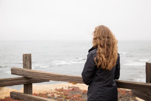 young woman looking out at the ocean