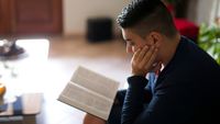 Family members reading and studying scriptures