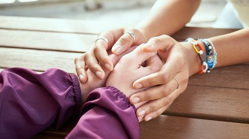 mujeres jóvenes tomadas de la mano