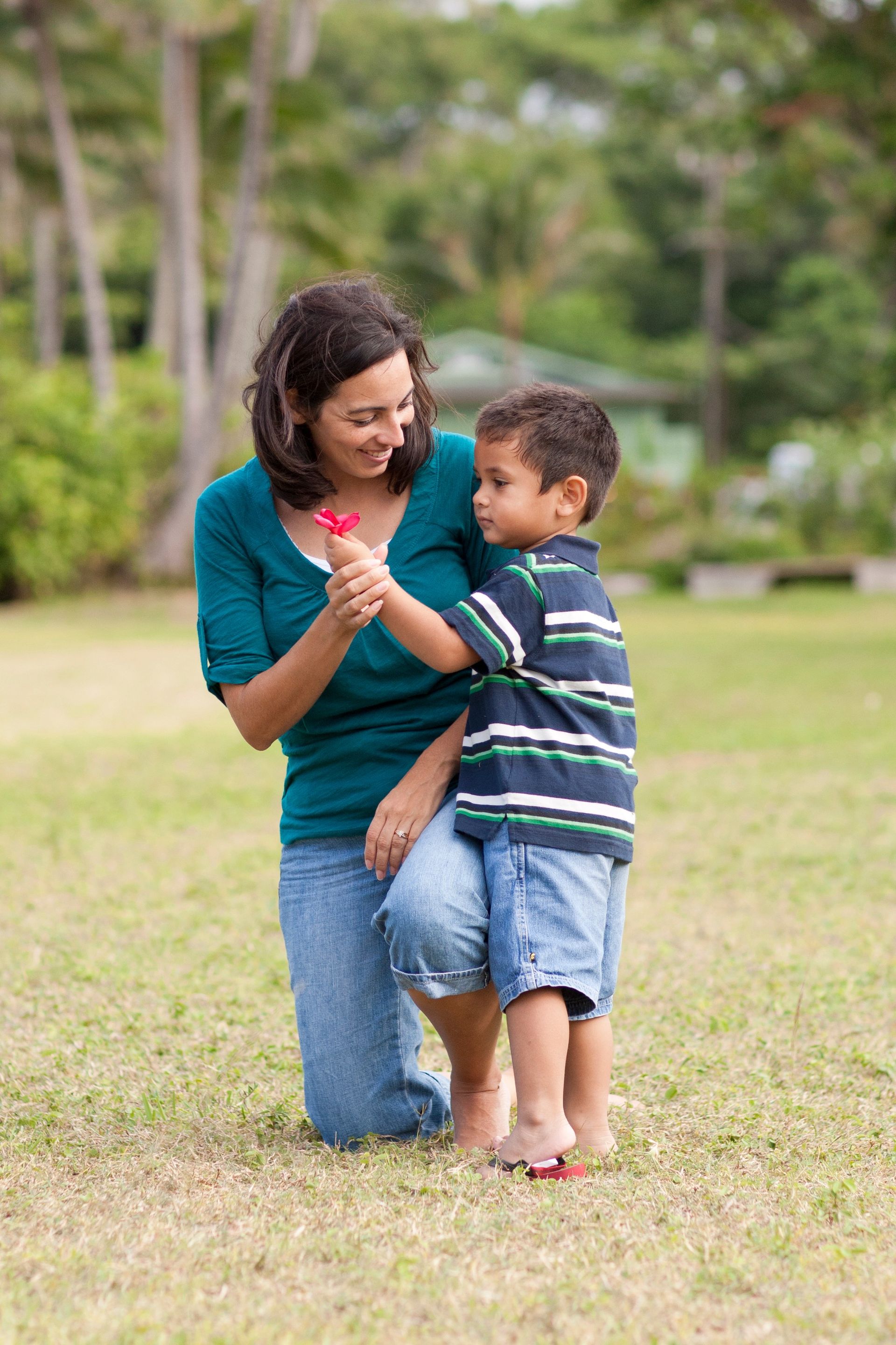 A mother in Hawaii gets a flower from her son.