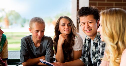 Young woman socializing with other youth