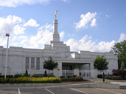 A view of the front of the Detroit Michigan Temple from the parking lot, with the white gate in view.