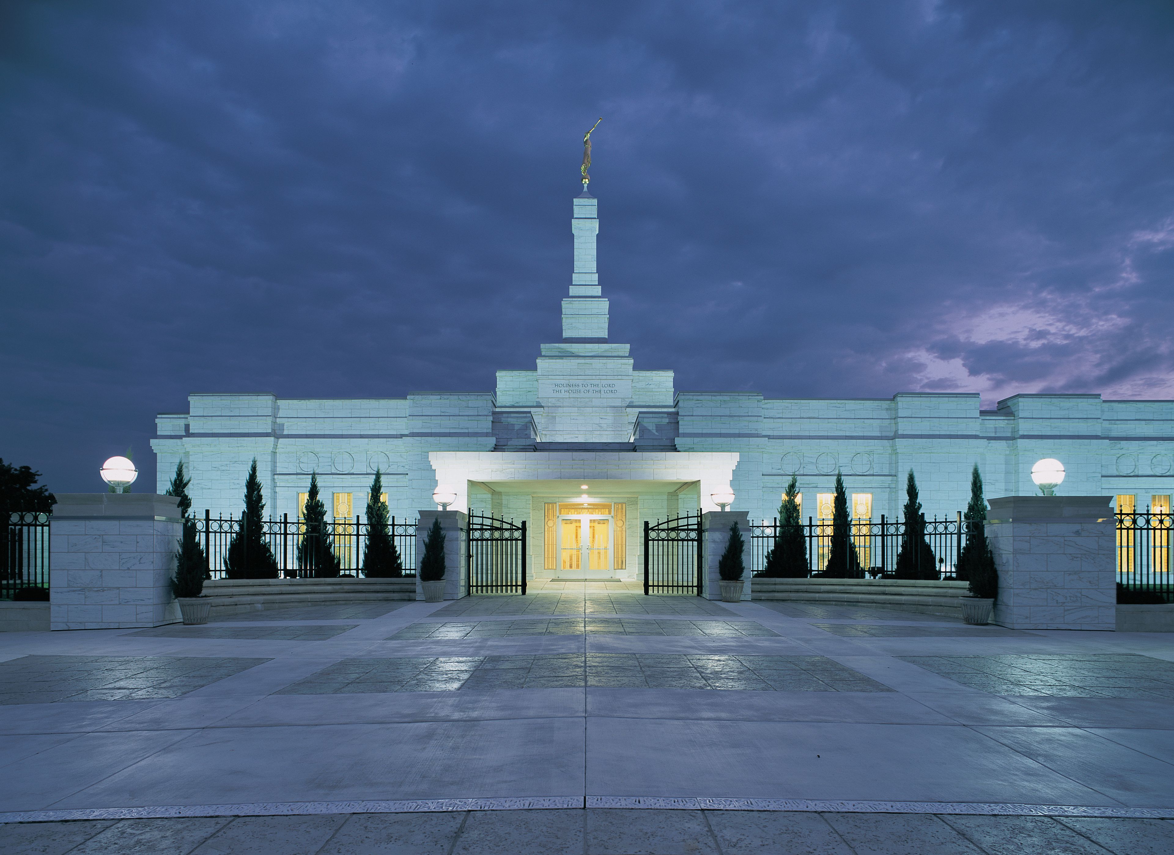 The Oklahoma City Oklahoma Temple in the evening, including the entrance and grounds.