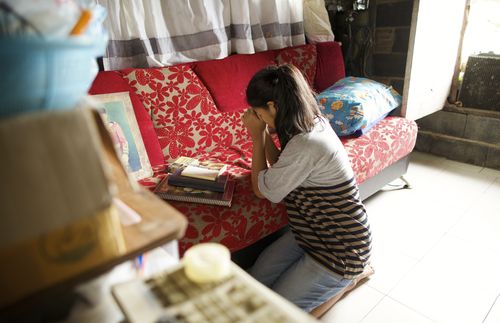 woman kneeling in prayer