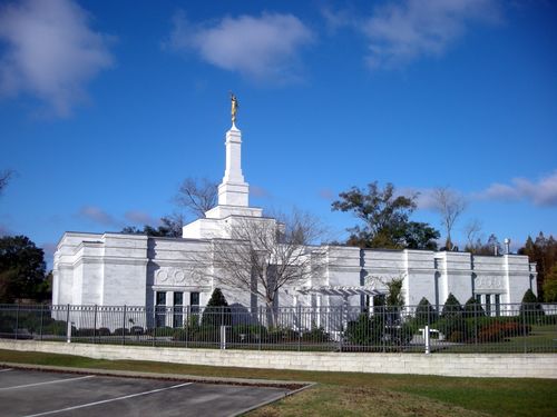 The back of the Baton Rouge Louisiana Temple in the daytime, with the surrounding gate seen in the foreground.