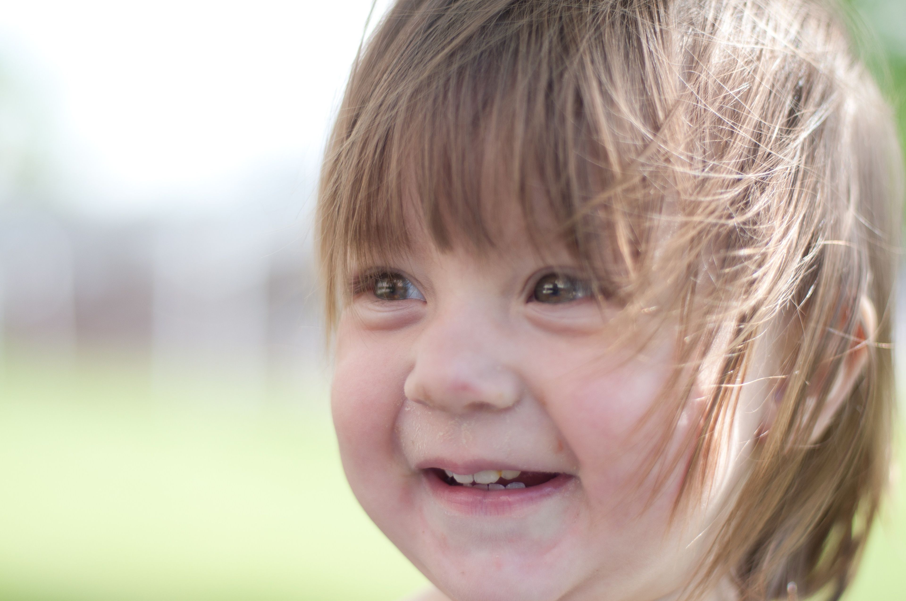 A toddler girl smiling.