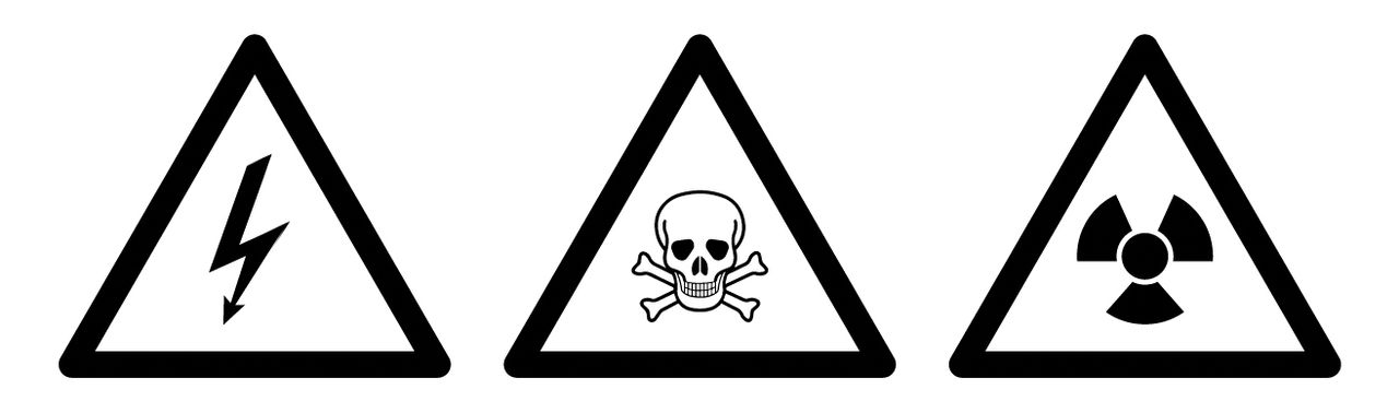An illustration of three common warning symbols: electrocution risk, poison, and radioactivity.