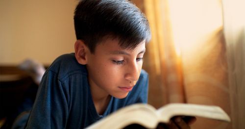 young man studying scriptures