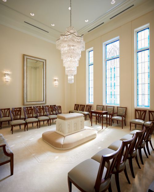 beautiful room with mirrors, chairs, and an altar to kneel at