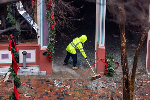 person cleaning up after explosion