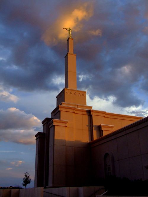 The spire on the Albuquerque New Mexico Temple, with the statue of the angel Moroni seen in the light of the sunset.