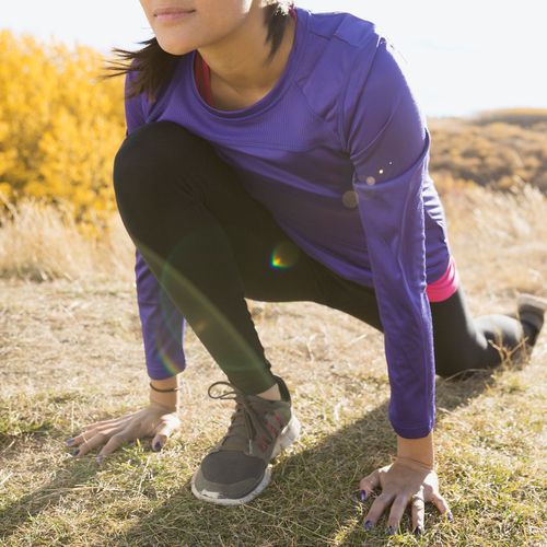 young woman stretching before a run