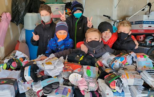 group of boys with all the socks they collected