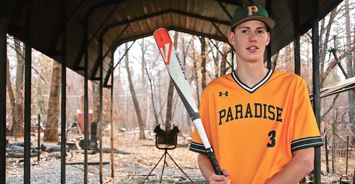 boy in burned-out batting cage