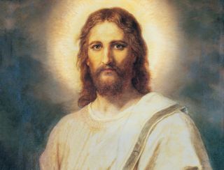 Frontal head and shoulders portrait of Jesus Christ. Christ is depicted wearing a pale red robe with a white and blue shawl over one shoulder. Light emanates from His face.