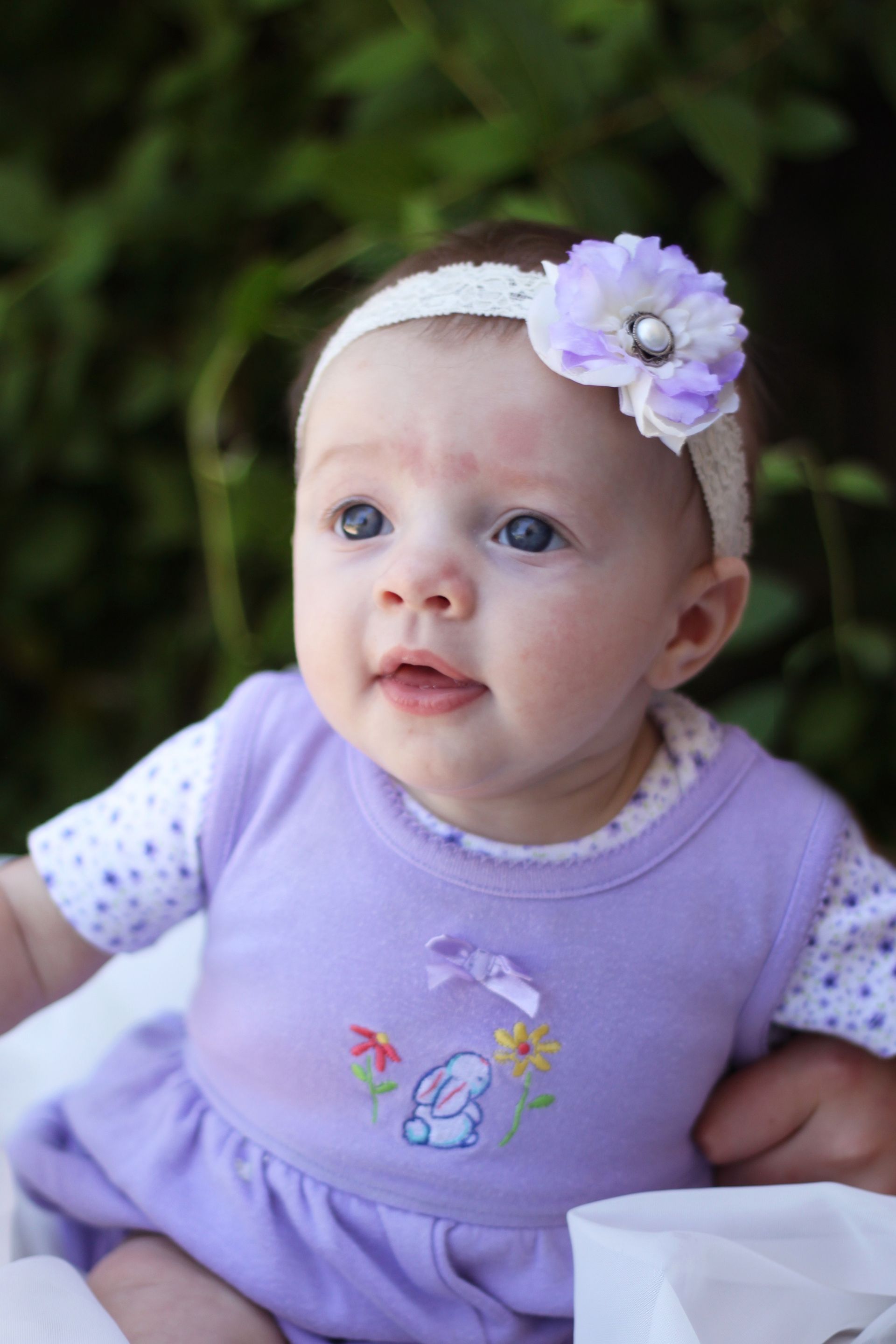 A baby girl with a flower headband.