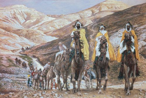 Three wise men traveling on camels through mountainous country as they journey to see the infant or young child Jesus Christ. The wise men are followed by a caravan of servants.