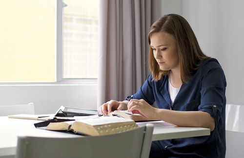 young adult woman studying scriptures