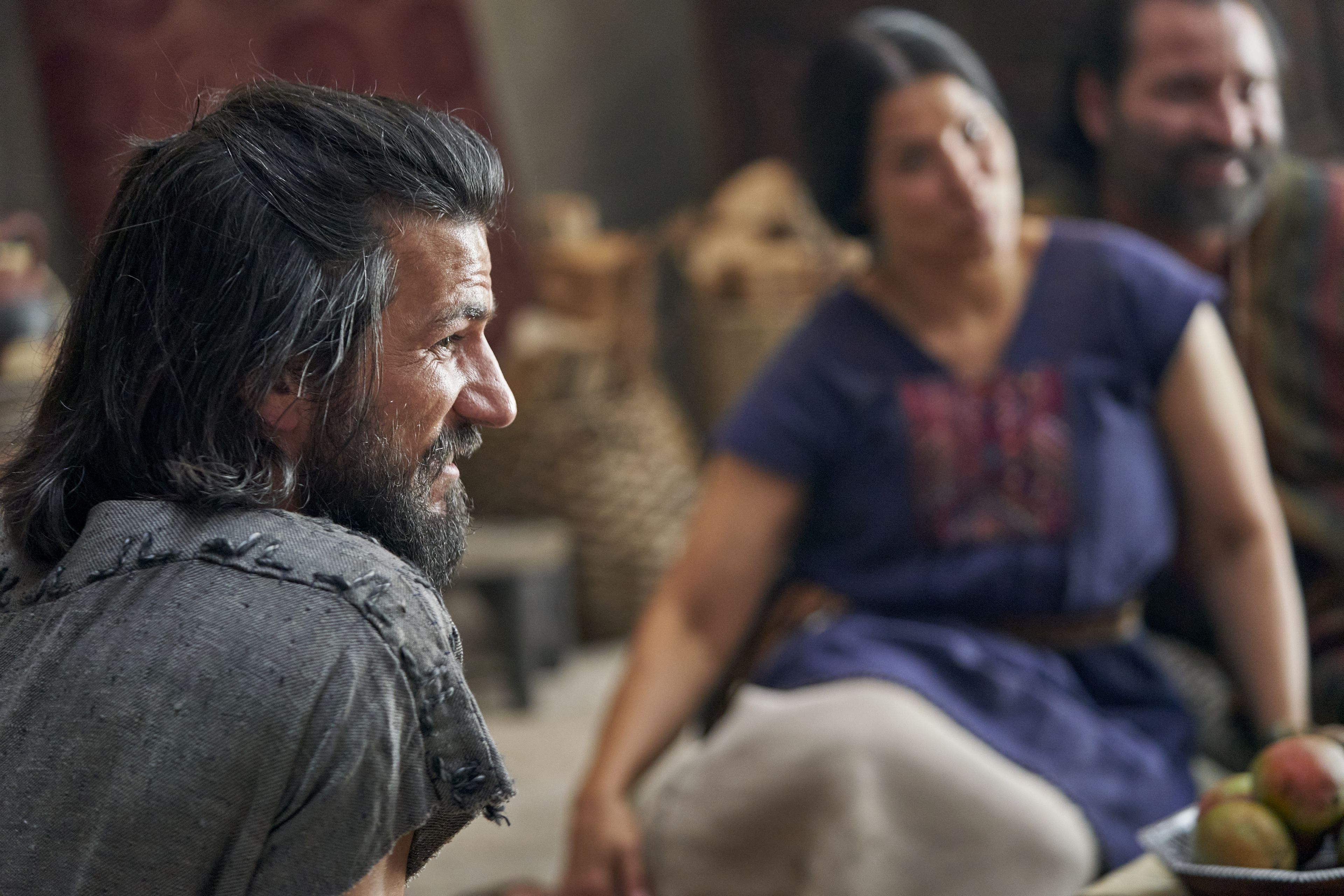 Alma the Younger listens with Amulek and his wife as they speak together in the house of Amulek in the city of Ammonihah.