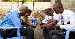 missionaries praying with man and woman